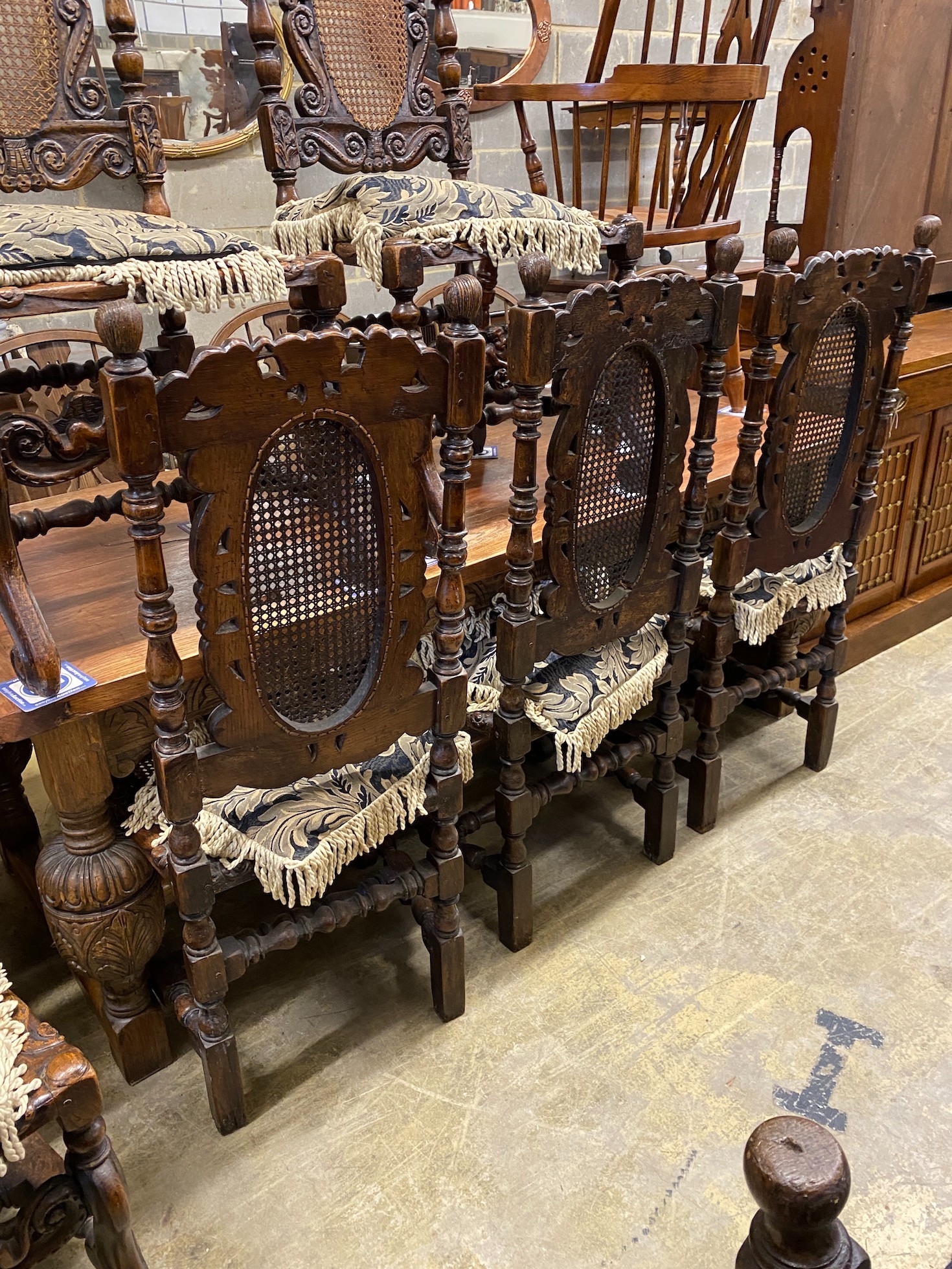 A set of six Carolean style caned oak dining chairs, width 54cm, depth 46cm, height 121cm